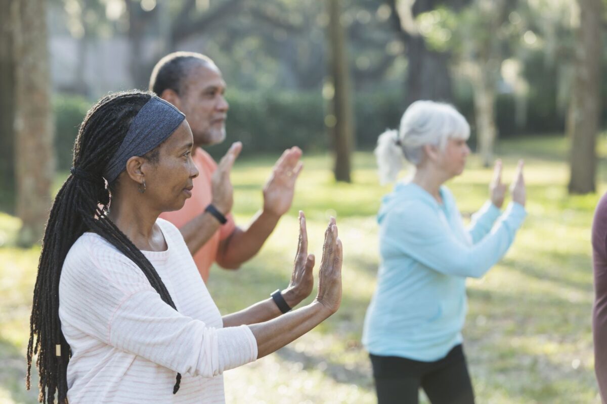 Seniors practicing Tai Chi in a park.