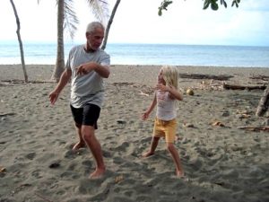 Grandfather and Granddaughter play Tai Chi on the beach.