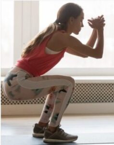 Woman posing in a perfect Kua Squat