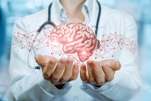 An illustration of a Physician holding a illuminated human brain.